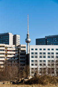 Buildings in city against blue sky