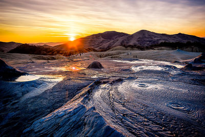 Scenic view of snowcapped mountains against sky during sunset