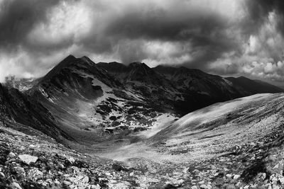 Scenic view of mountains against cloudy sky