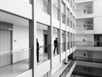 Rear view of people walking on building