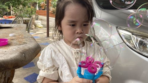 Portrait of cute girl holding flowers