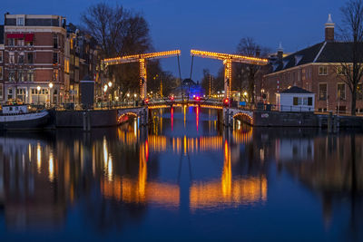 Reflection of illuminated buildings in river at night