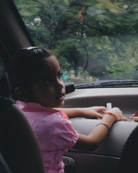 Rear view of woman sitting in train