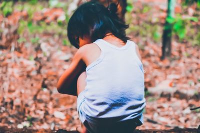 Rear view of woman standing on field