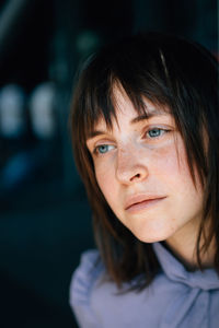 Close-up of beautiful young woman looking away