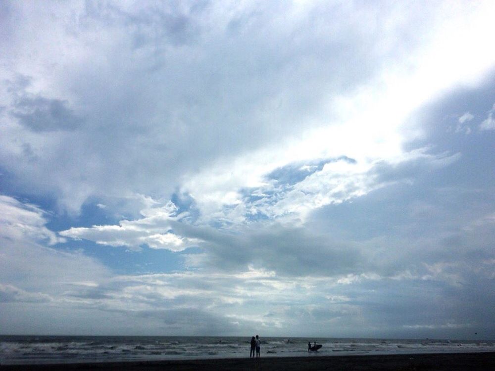 sea, sky, scenics, tranquility, beauty in nature, beach, water, horizon over water, tranquil scene, cloud - sky, men, nature, cloudscape, vacations, majestic, tourism, cloudy, cloud, outdoors, day, shore, non-urban scene, person, solitude