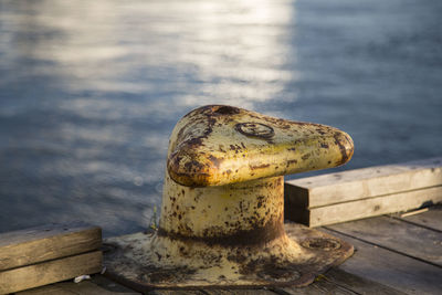 Close-up of cleat on pier at harbor