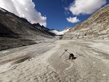 Rear view of person on snowcapped mountain against sky