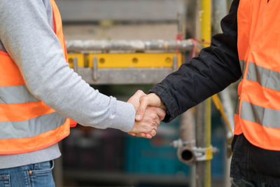 Close-up of architects shaking hands