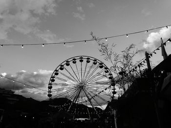 Low angle view of ferris wheel against sky