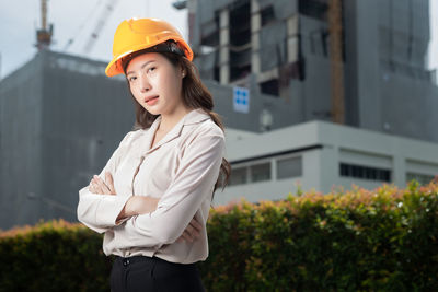 Portrait of a smiling young woman standing outdoors