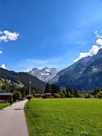 Scenic view of field and mountains against sky