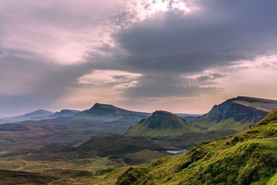 Scenic view of mountains against cloudy sky