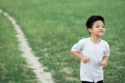 Boy standing on field