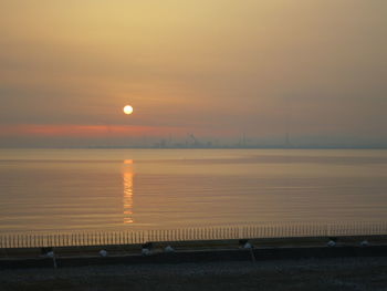 Scenic view of sea against orange sky