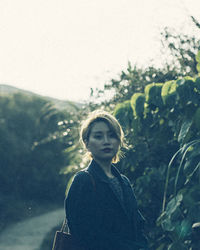Close-up of woman standing against white background
