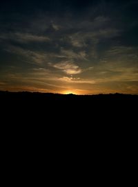 Silhouette landscape against sky during sunset