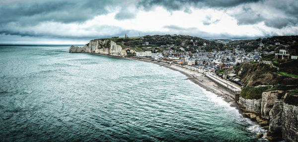 Panoramic view of sea and buildings against sky