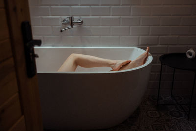 Women's smooth legs in the bath. bath procedures, skin care, depilation. personal selfcare