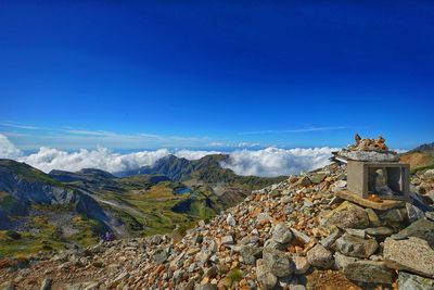 Panoramic shot of building and mountains against blue sky