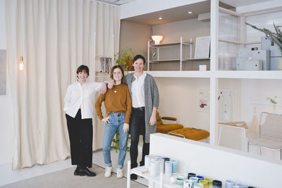 Full length portrait of female interior designers standing in store