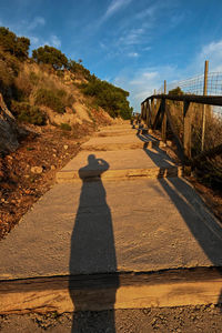 Shadow of man on footpath