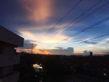 Silhouette buildings against sky during sunset