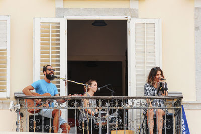 People standing against railing