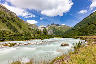 Scenic view of lake amidst mountains against sky