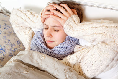 Portrait of woman sleeping on bed at home