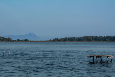 Scenic view of lake against clear blue sky