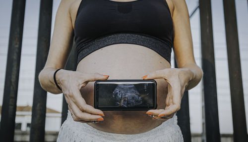 Woman photographing with mobile phone