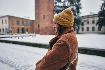 Rear view of woman standing on snow