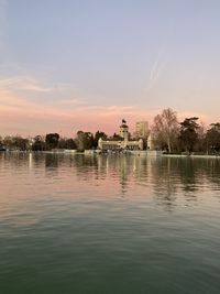 Scenic view of lake against sky at sunset