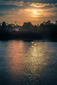 Scenic view of lake against sky during sunset