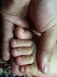 Close-up of baby holding hands