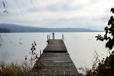 Pier over lake against sky