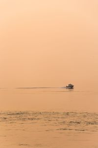 Scenic view of sea against orange sky