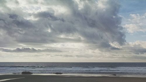 Scenic view of sea against cloudy sky