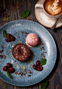 Directly above shot of molten chocolate cake with ice cream and berry fruits in plate