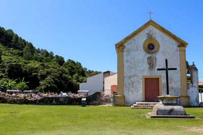 Church by building against clear sky