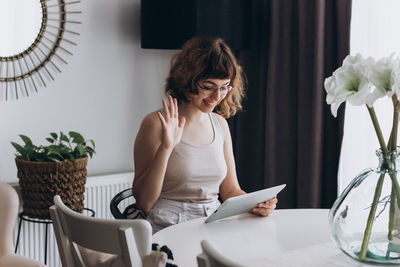 Woman sitting on table at home