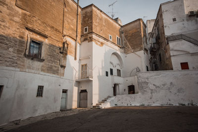 Low angle view of old building against sky in city