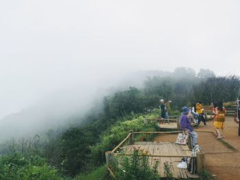 People on landscape against sky