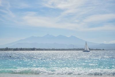 Sailboat sailing on sea against sky