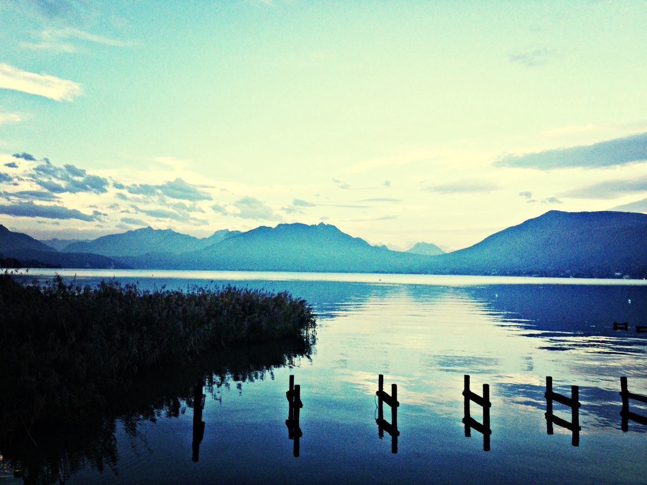 mountain, mountain range, water, lake, tranquil scene, tranquility, scenics, reflection, beauty in nature, sky, nature, waterfront, idyllic, cloud - sky, calm, cloud, non-urban scene, outdoors, lakeshore, countryside