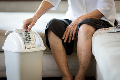 Low section of people sitting on floor