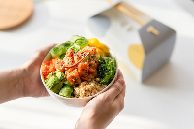 Close-up of person holding food on table