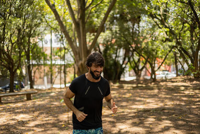 Man running and jogging at a park outdoors. male person workout. feel good, healthy concept. 
