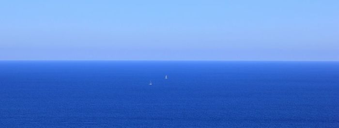 Scenic view of calm sea against clear sky